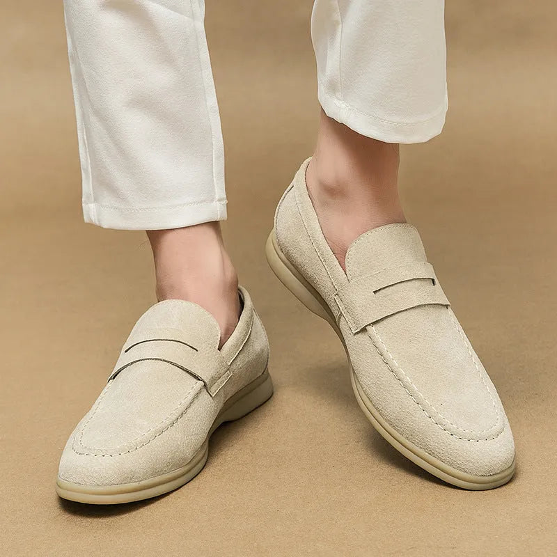 Men's black leather slip-on casual shoes with a round toe and rubber sole on a white background.