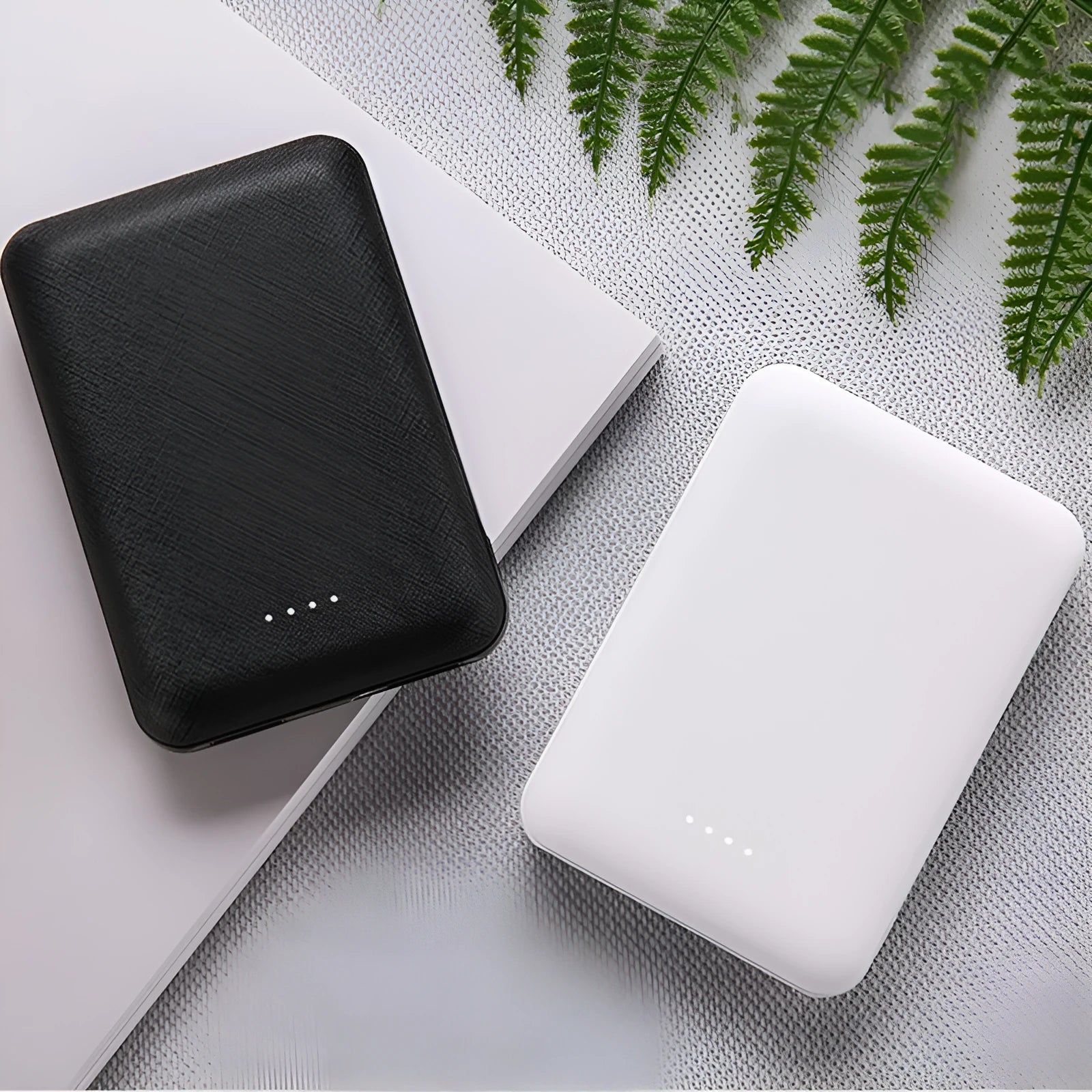 Black or white 10000mAh ultra-thin power bank with multiple USB ports showing 90mm x 63mm x 22mm dimensions