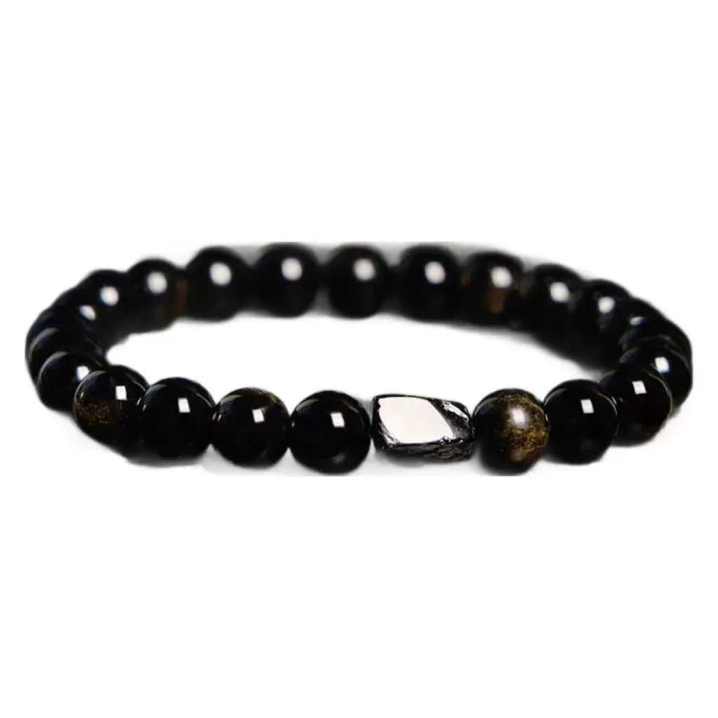 Natural obsidian single ring bracelet with constellation modelling on a wrist.