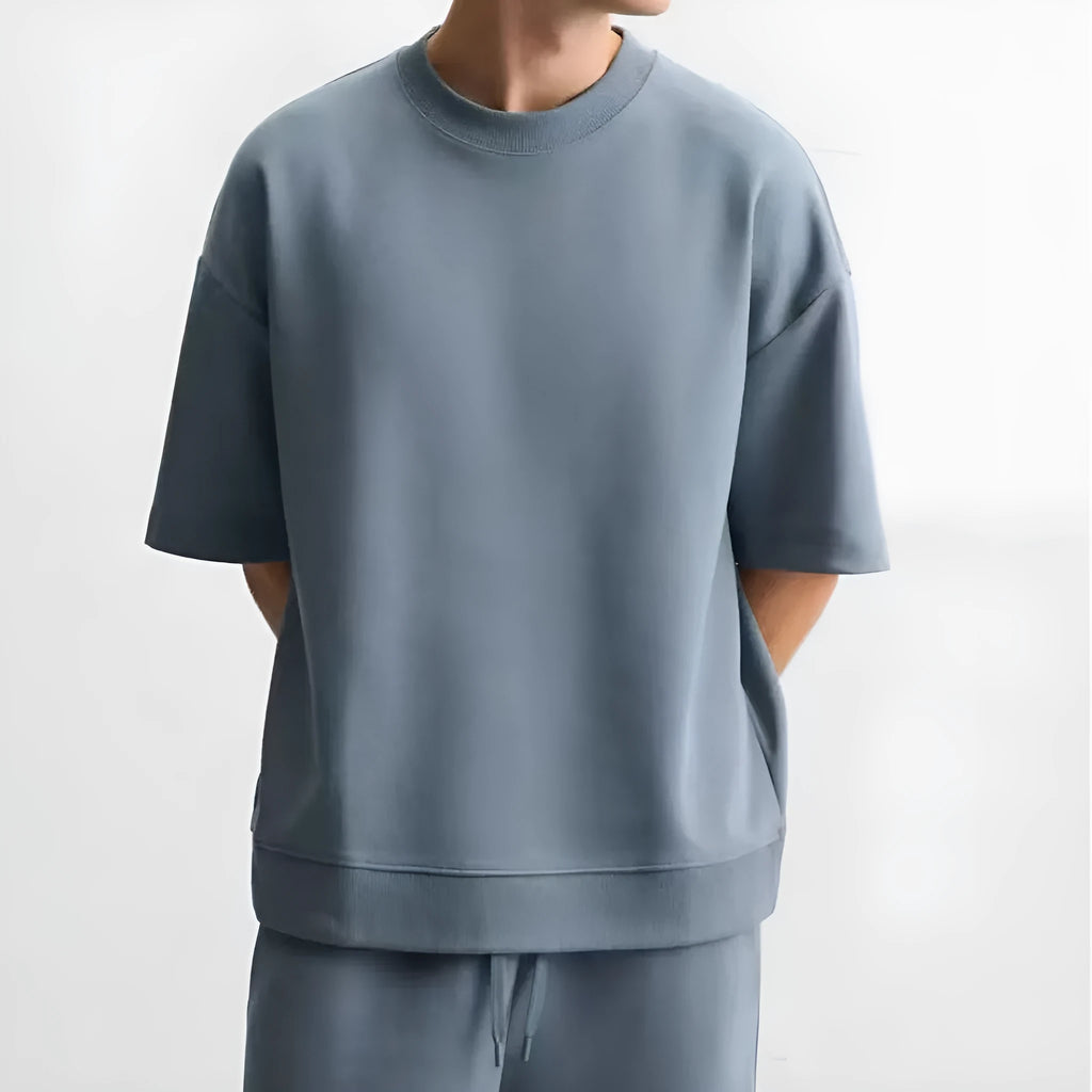 Loose blue polyester short sleeve top and matching shorts set on a hanger.