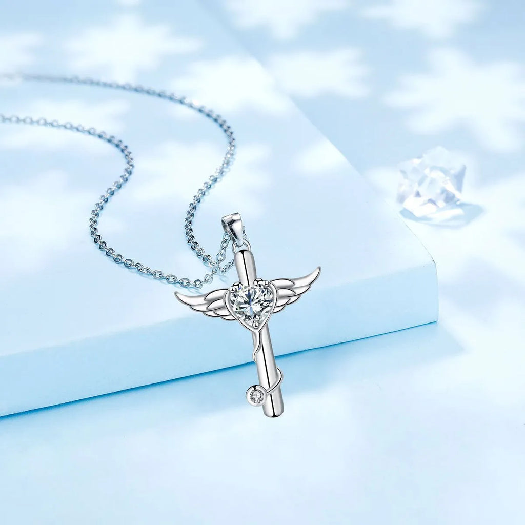 Close-up of a women's necklace with a cross, stethoscope, and wings pendant in electroplated copper.