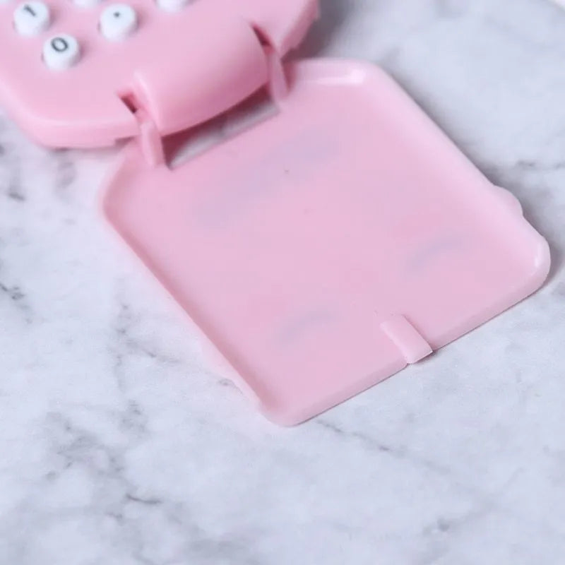 Cookie-shaped mini plastic calculator with key ring, 6.4cm x 3.6cm x 11.2cm, in pink, blue, grey, or black