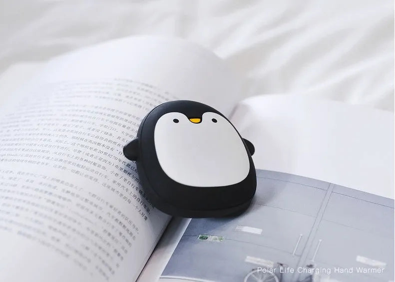 Cartoon penguin polar bear USB rechargeable hand warmer and power bank unit.