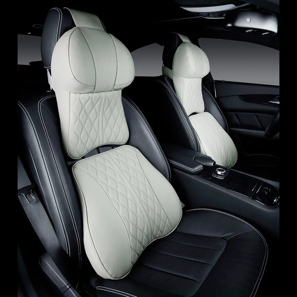 Beige and black car neck pillow and matching lumbar support pillow with wavy pattern.