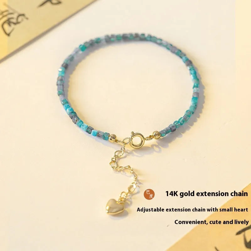 Women's blue apatite crystal bracelet with diamond-shaped beads on an elasticated band.