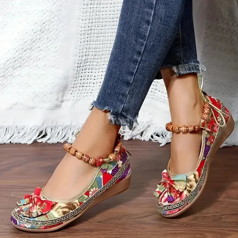 Women's black ethnic platform sandals with elastic band and cloth upper on a plus-size foot.