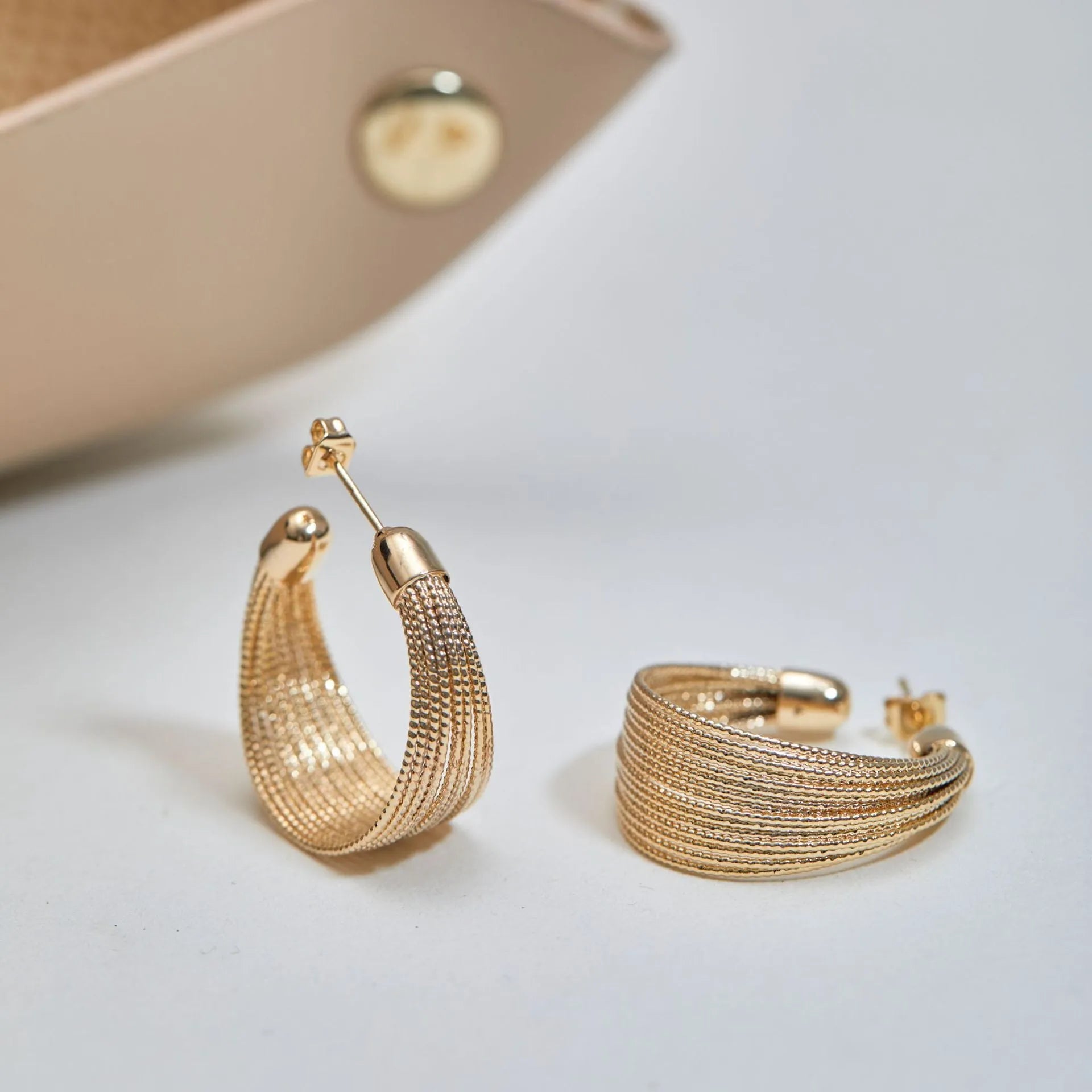 Copper geometric multi-layer bracelet earrings with electroplated silver and gold finish showing stud and clip pieces