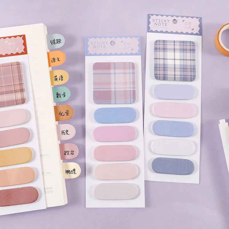 Colourful plaid sticky note memo pad showing eight different designs including blue, pink, and green patterns