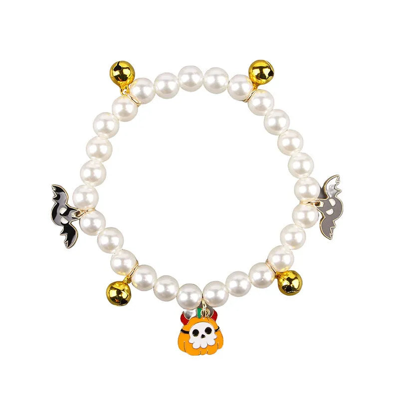 Halloween pet collar with simulated pearls and a purple ghost pumpkin charm around a cat's neck.