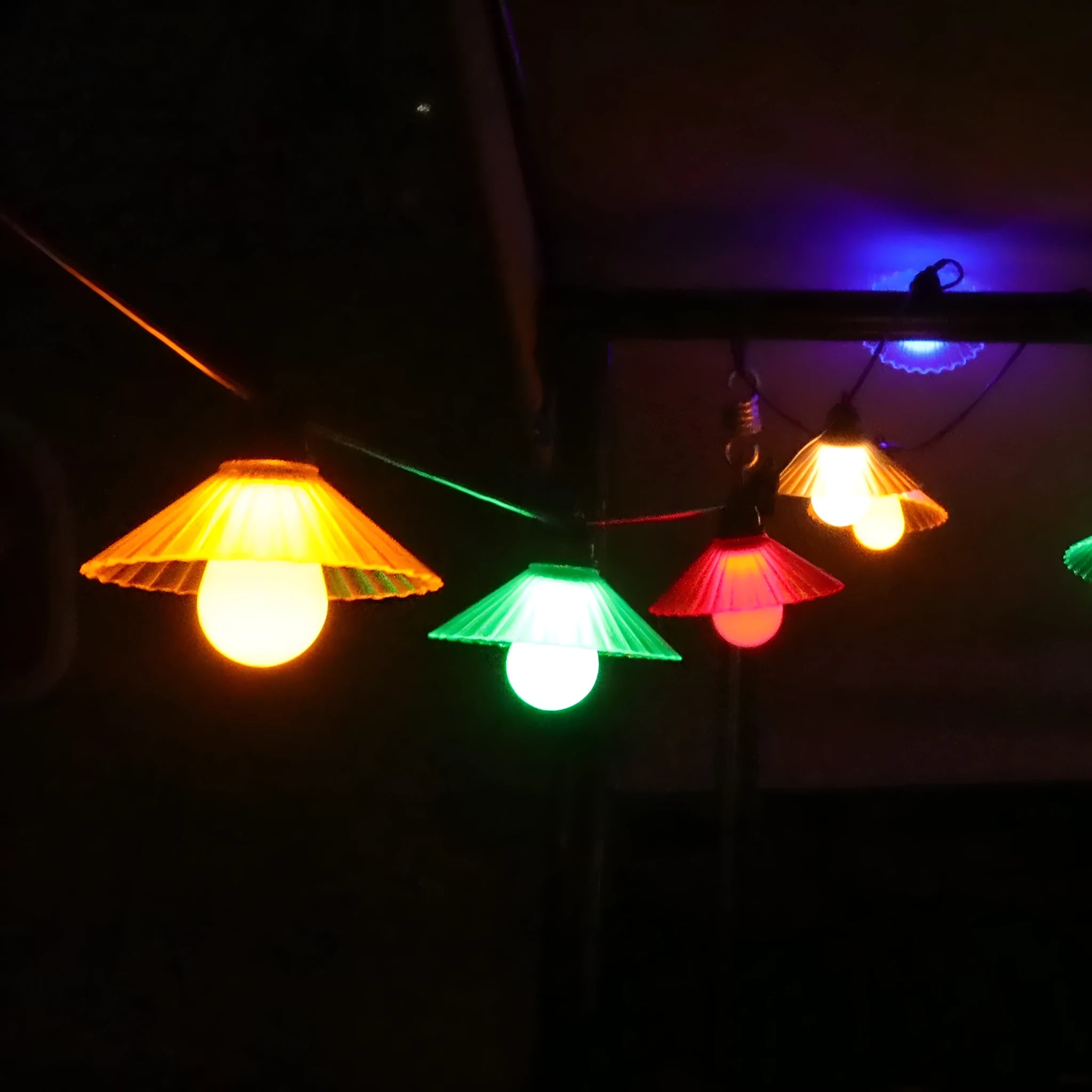 Outdoor LED string lights with flower-shaped bulbs in warm white and multi-colour options.