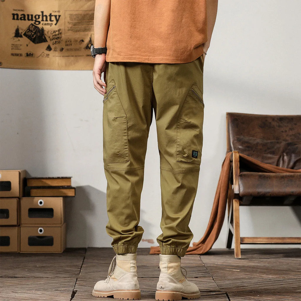 Men's tapered harem trousers in cotton with ankle band and zip placket front