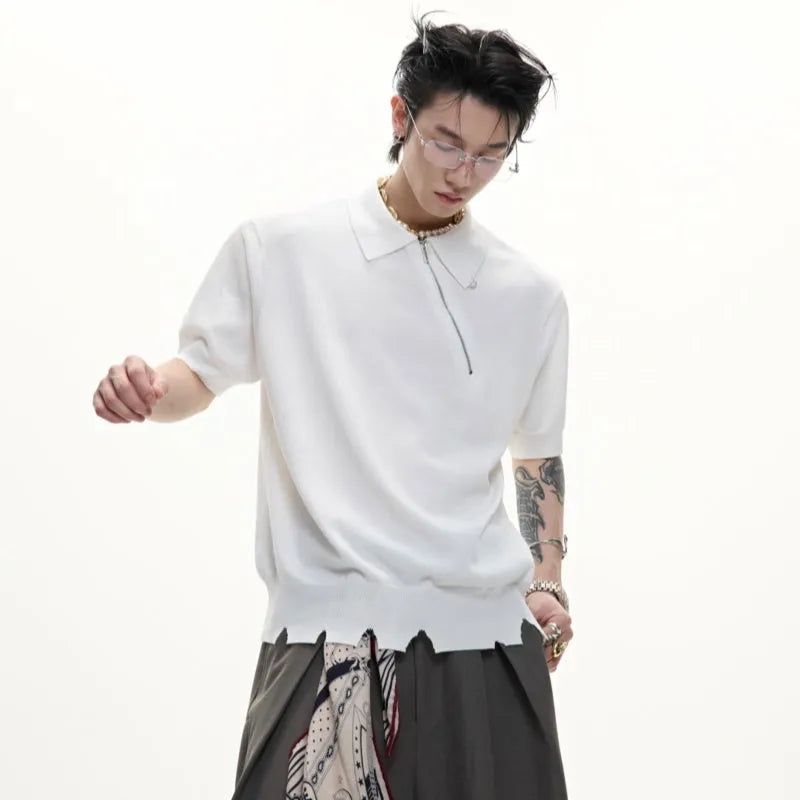 Man modelling a slim-fit black knitted polo shirt with an oblique zip closure and short sleeves.
