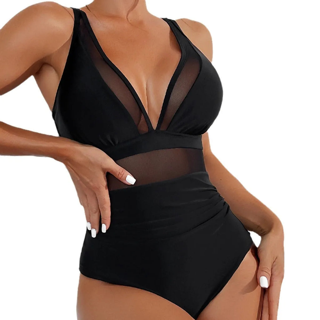 Black halter neck one-piece swimsuit with bikini style briefs, made from nylon fabric.