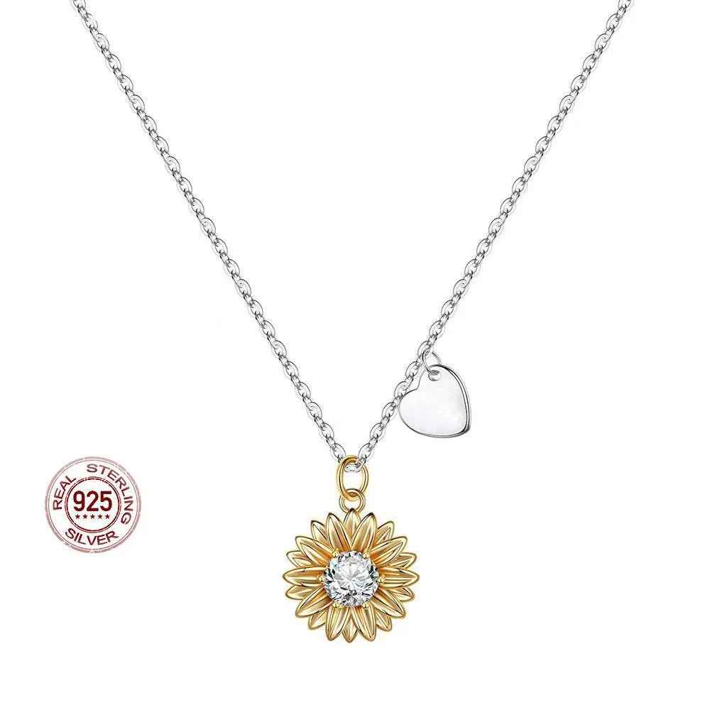 Close-up of a geometric sunflower pendant necklace on an adjustable silver cross chain.