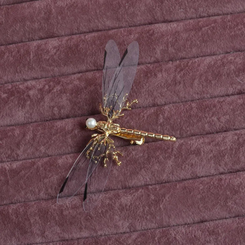 Golden dragonfly-shaped women's headdress with side clip on white background