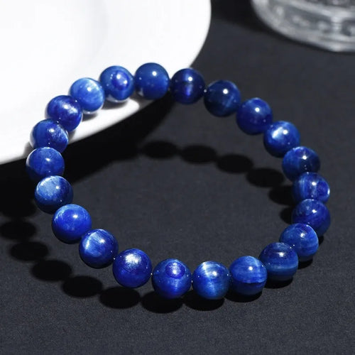 Natural blue crystal ball bracelet with geometric shape and Ruyi design on a white background.