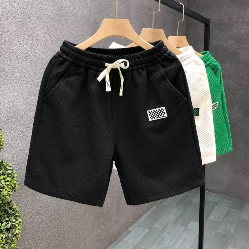 Men's solid colour casual sports shorts with micro elasticity in white, black, or green options
