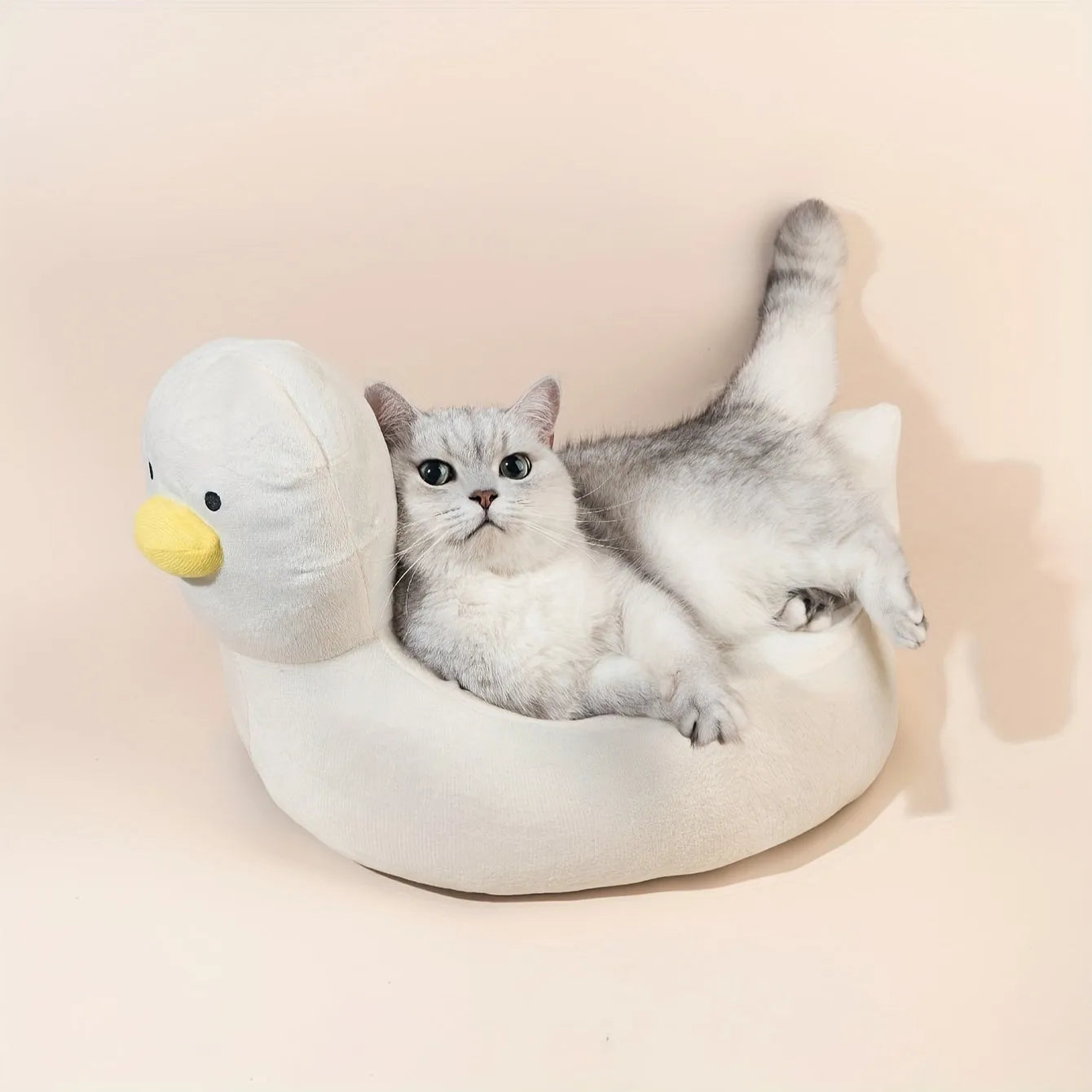 Blue duck-shaped fluffy pet bed sofa for small dogs and cats on wooden floor
