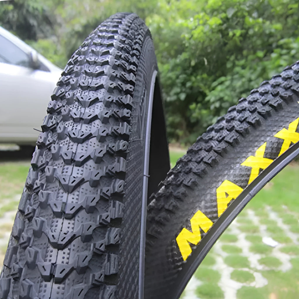Ultralight mountain bike tyre with puncture-resistant tread, shown in a black and white sidewall style.