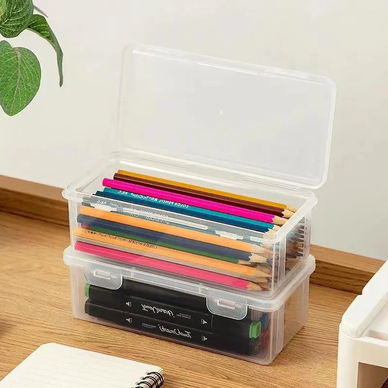 Large transparent plastic storage box full of coloured pencils and crayons
