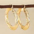 Women's geometric ear clip earrings with drop-shaped ring design in copper with electroplated finish