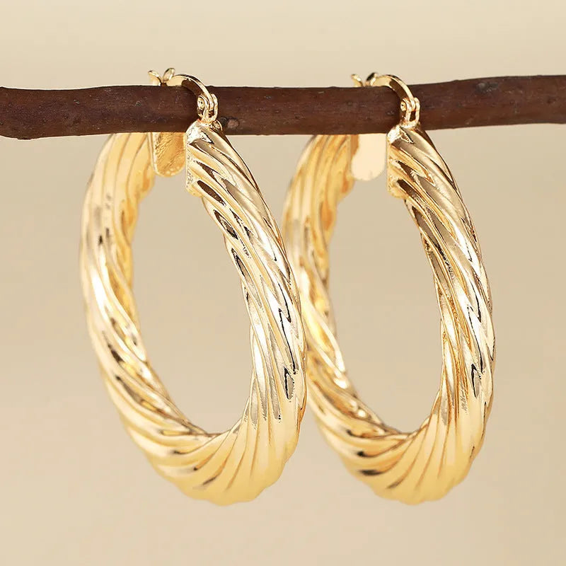 Women's geometric ear clip earrings with drop-shaped ring design in copper with electroplated finish