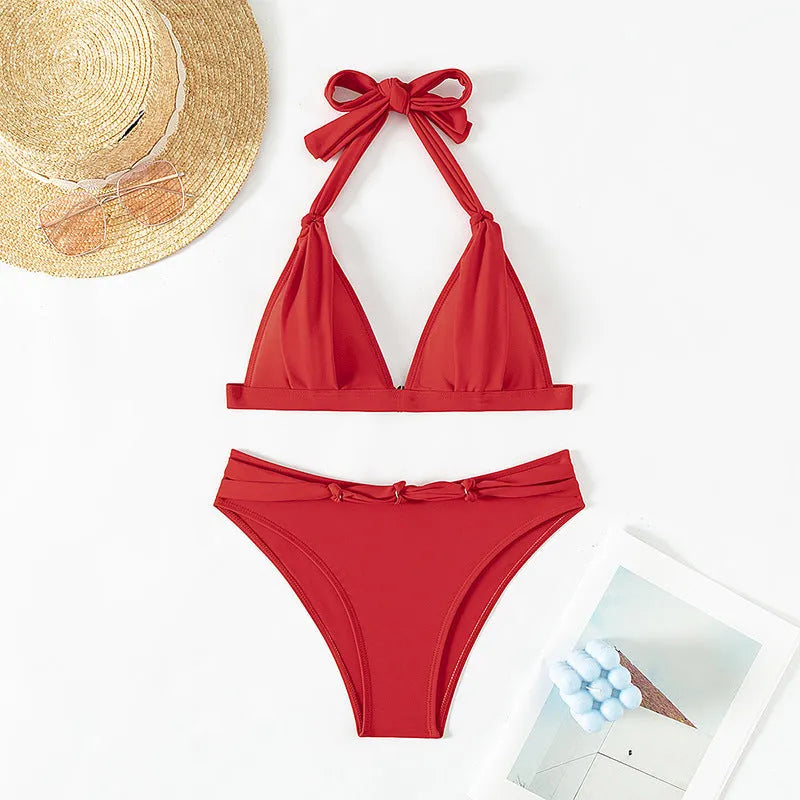 Red women's lace-up halterneck bikini set with matching shorts