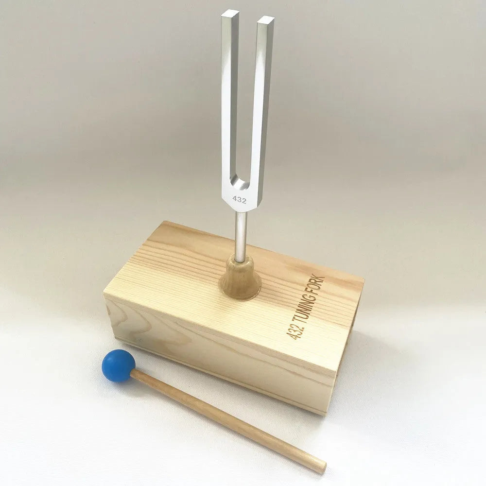 Aluminium alloy 432Hz tuning fork and portable speaker kit on a kraft paper box.