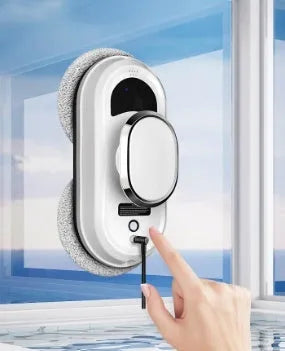 White automatic high-altitude cleaning machine with remote control on a windowsill.