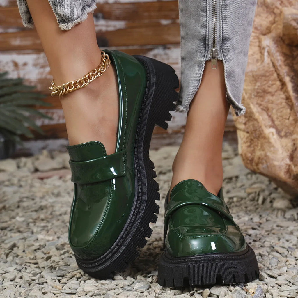 British-style slip-on loafers with a chunky mid heel and thick rubber platform sole.