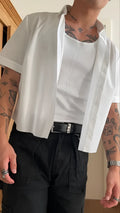 Men's white cropped short sleeve polyester shirt laid flat, showing plain design and regular fit.