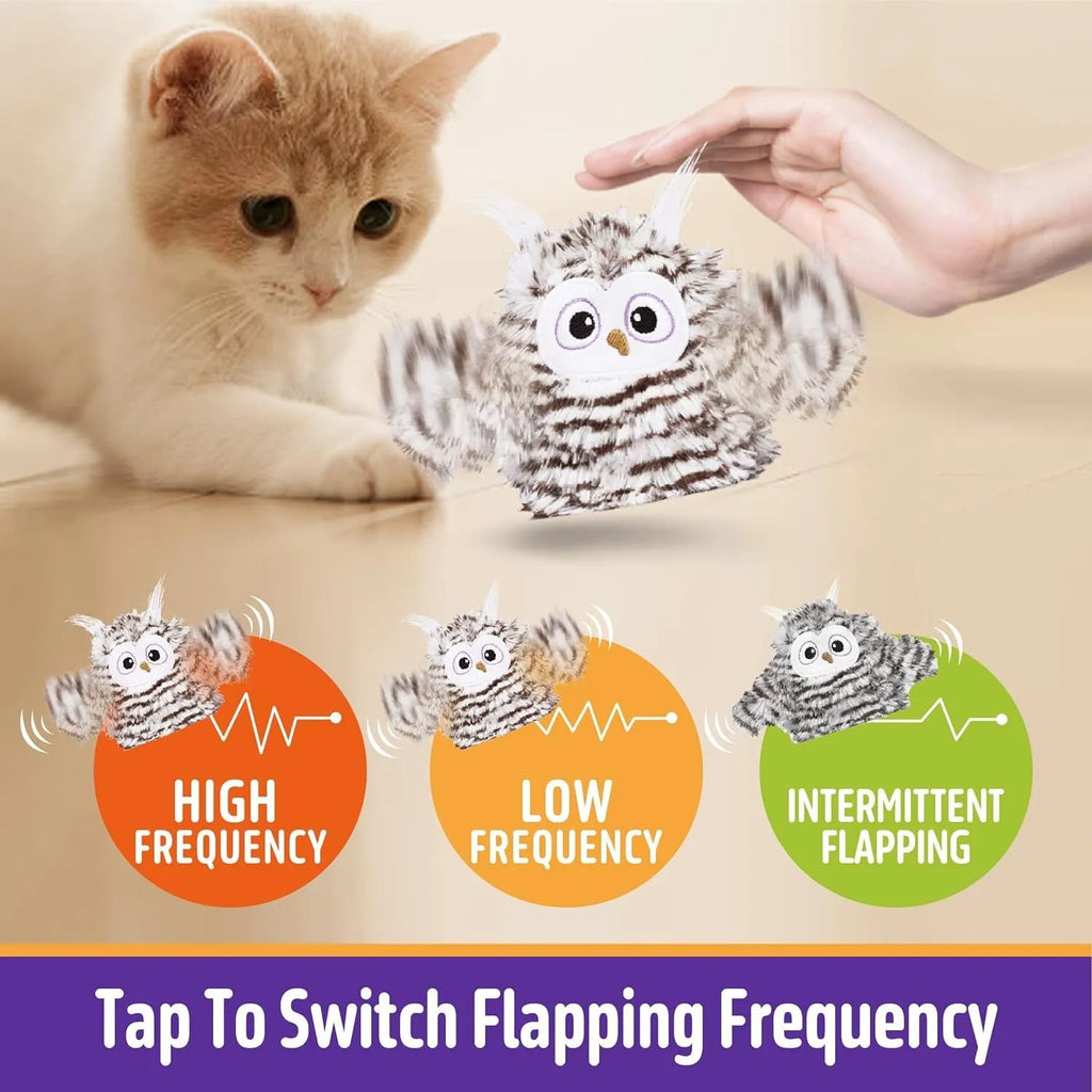 Grey automatic owl cat toy with flapping wings on a flat surface