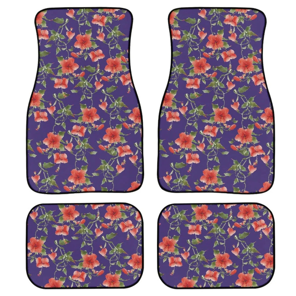 Set of four black rubber car floor mats with a textured surface and raised edges, shown in a vehicle footwell.