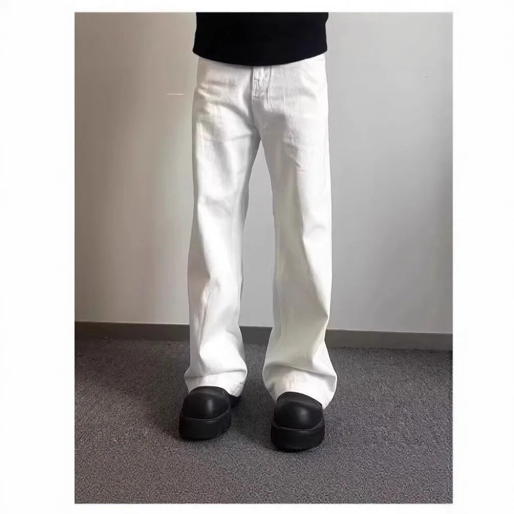 Man wearing white straight-leg cotton denim jeans with a wide leg opening.