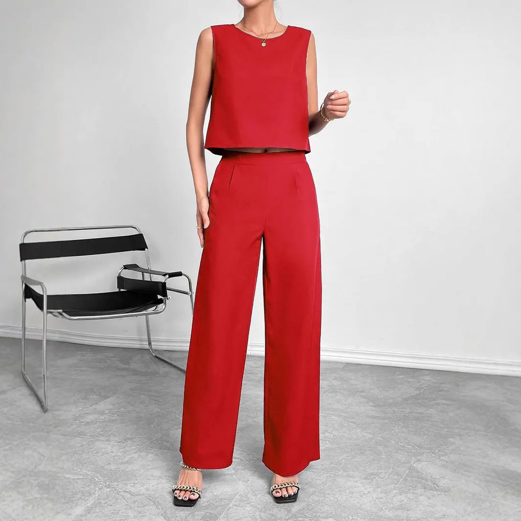 Red women's sleeveless top and wide leg trousers two-piece co-ord set.