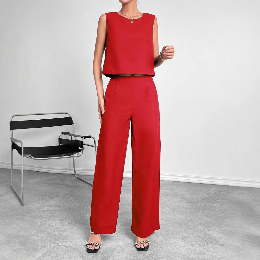 Red women's sleeveless top and wide leg trousers two-piece co-ord set.