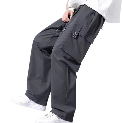 Boys' straight-leg cargo trousers in army green with large pockets and a drawstring waistband.
