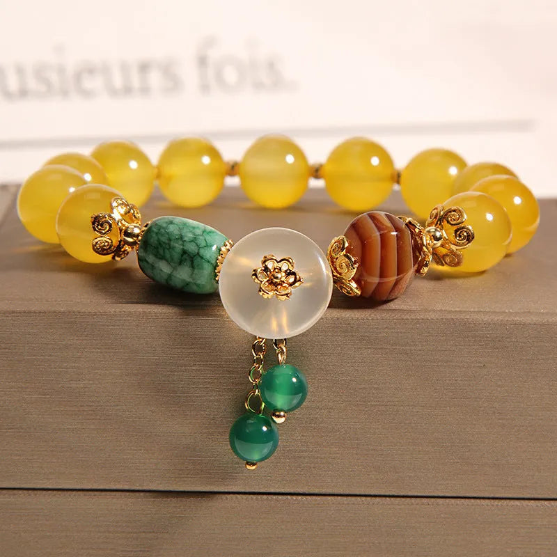 Yellow agate crystal bead bracelet on a gold silk cord with an adjustable metal clasp.