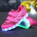 Children's plum red and white LED light-up trainers with USB charging port on the side.