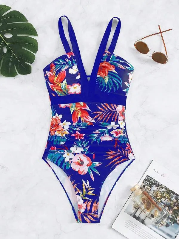Women's floral pattern backless one-piece swimsuit on a hanger.
