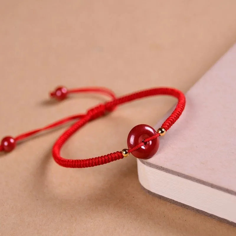 Cinnabar heart charm bracelet with adjustable red rope and traditional safety buckle in multiple colour options