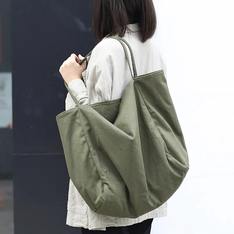 Large canvas shoulder tote bag in solid colour with soft handle, open top, and internal phone pocket