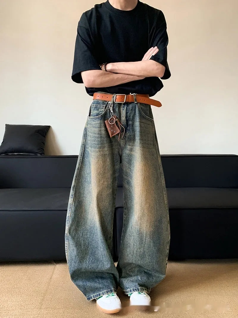 Man wearing Retro Blue distressed wide-leg denim jeans with a slimming silhouette and mid-waist fit.