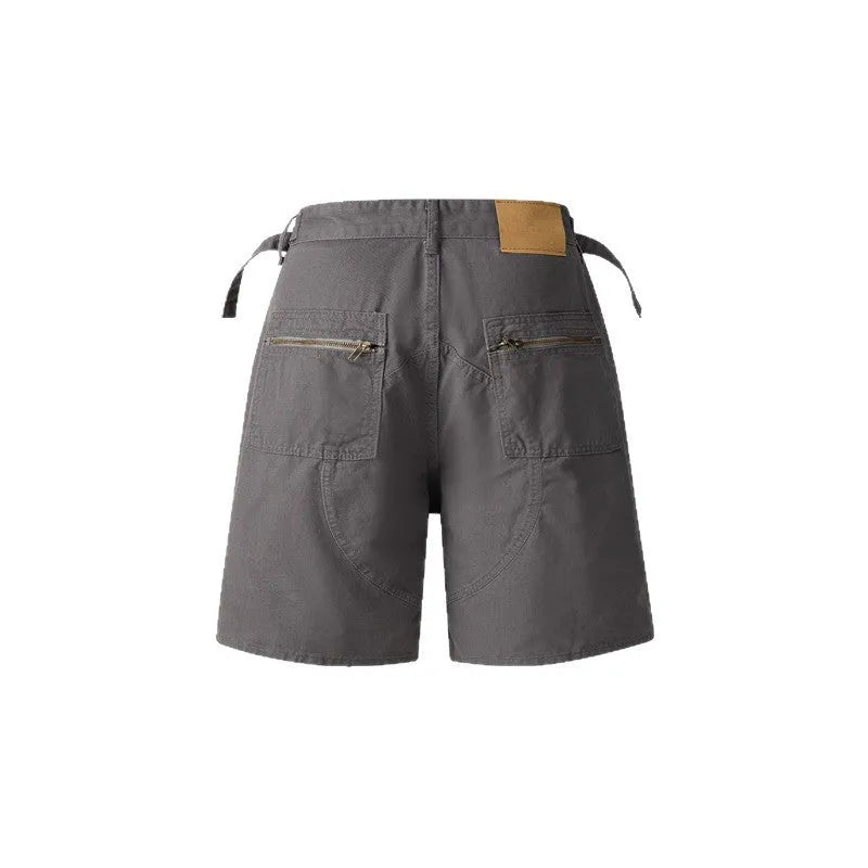 Retro loose-fit washed cotton shorts in camouflage with a zipper pocket.