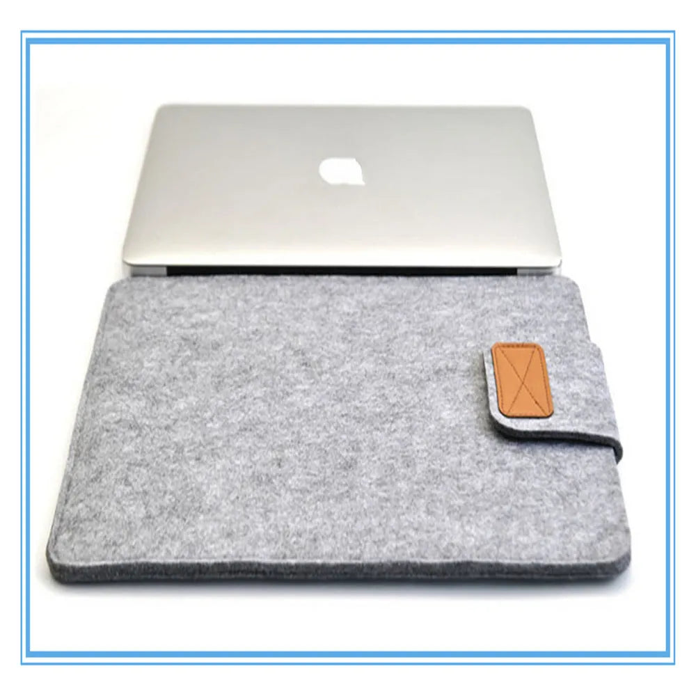 Dark grey plush felt vertical clutch laptop bag showing clamshell opening and structured interior.