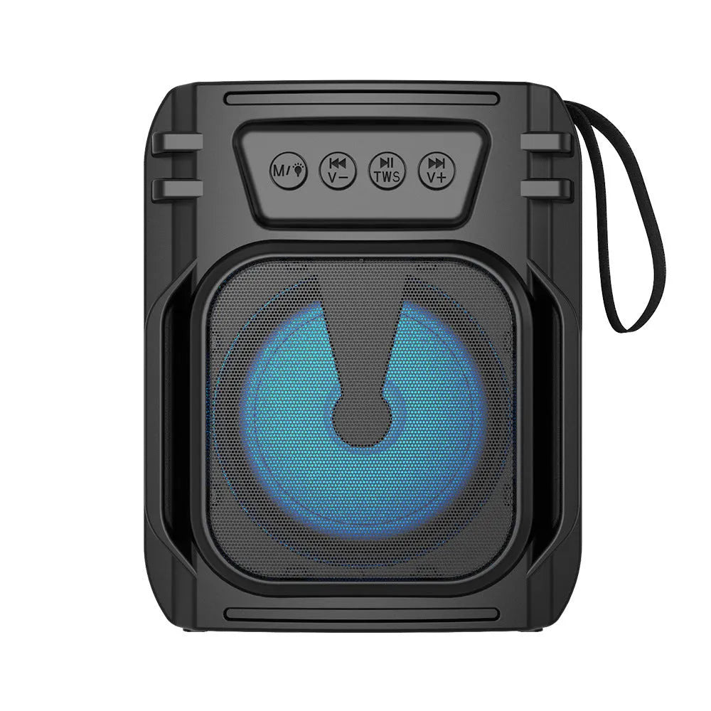 Compact rectangular portable Bluetooth speaker with USB charging cable on a desk.