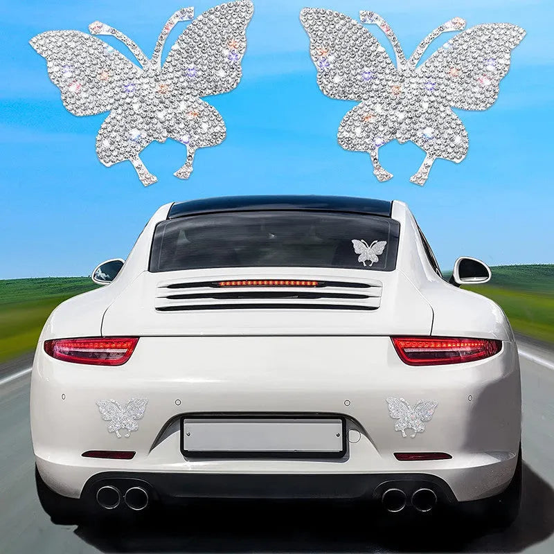 Close-up of a white diamond glass car sticker with a butterfly and bear paw design.