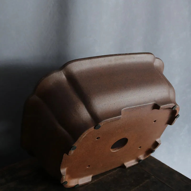 A rectangular purple sand clay bonsai pot on a floor, showing its modern simple design.