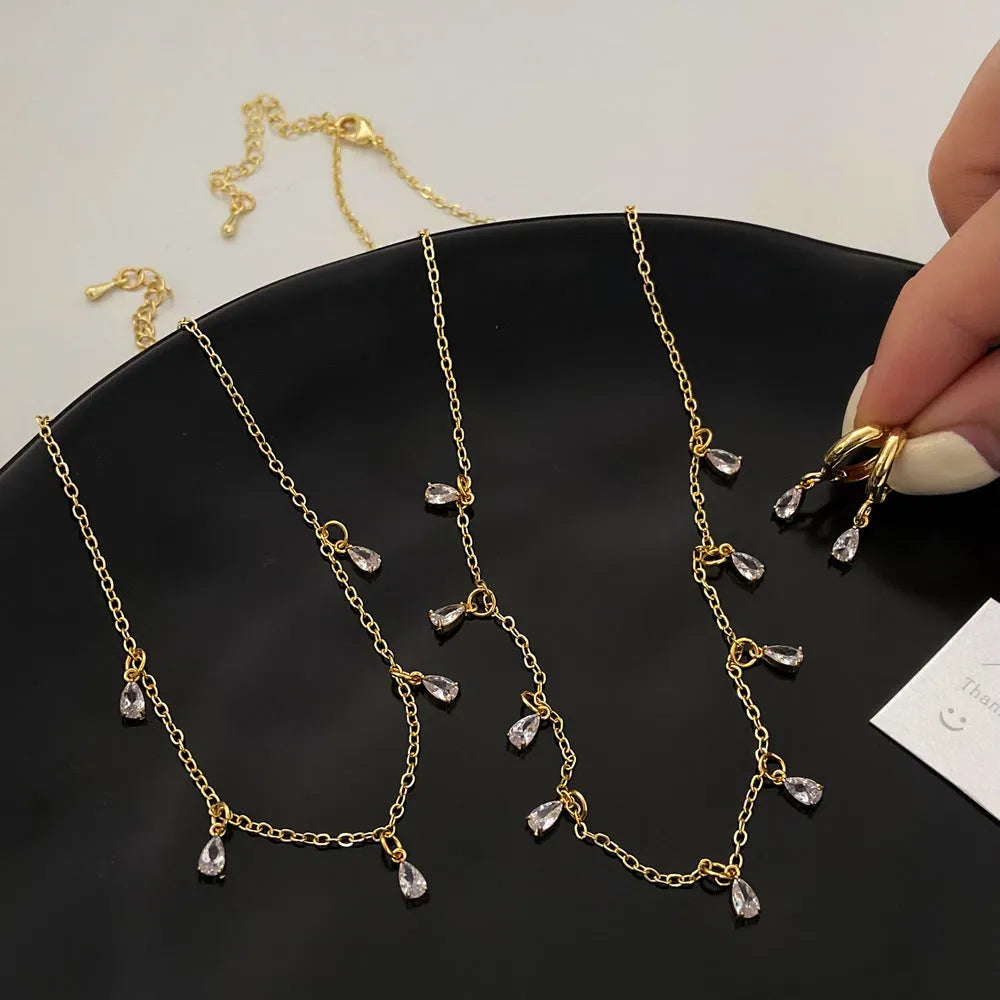 Women's zircon jewellery set showing necklace, earrings, and anklet with geometric meteor shower design.