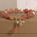 Women's bracelet with pink strawberry quartz stones, white freshwater pearls, and sparkling zircon on an alloy chain.